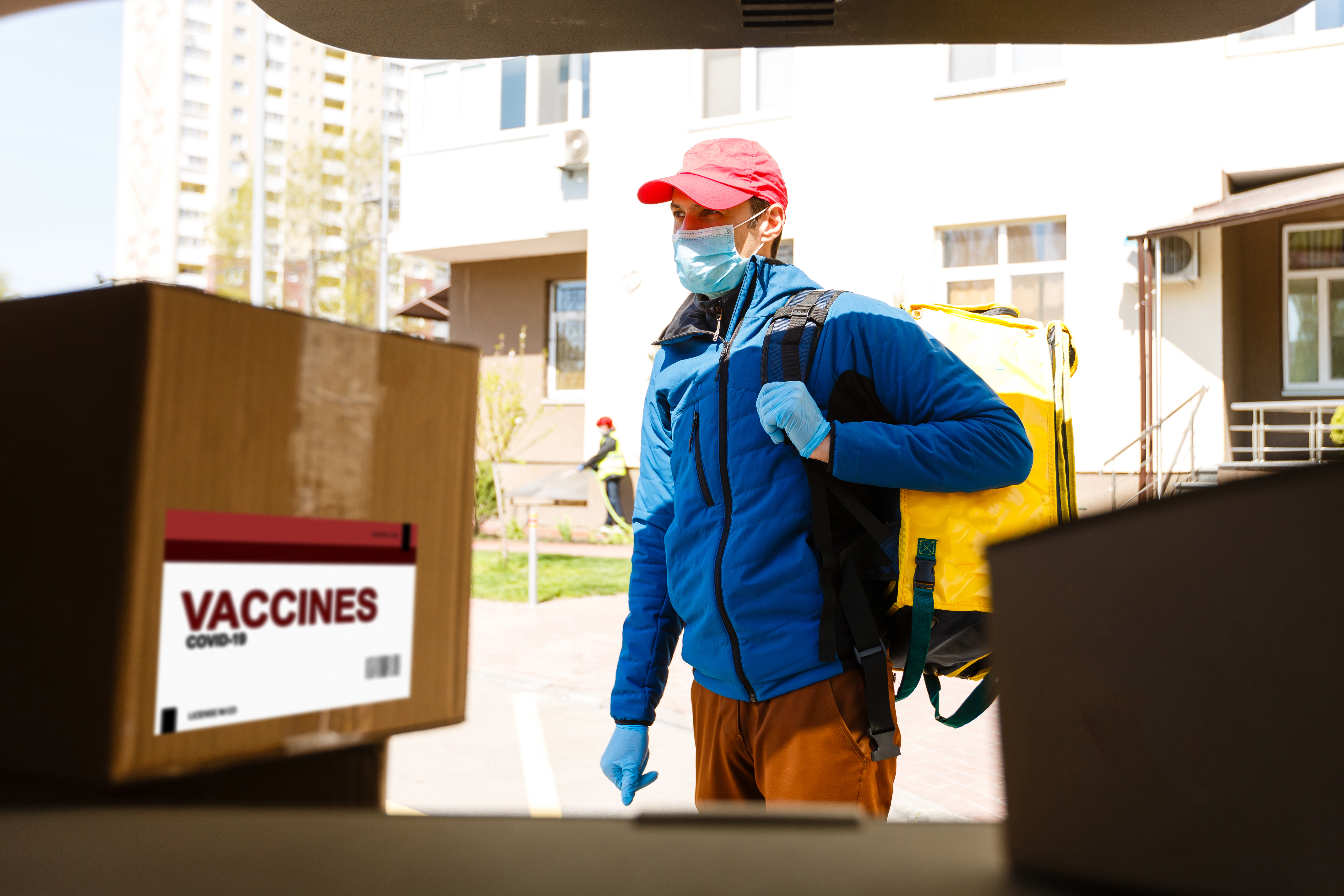 2025-05_man-delivers-vaccine-placing-label-1940726833.jpg