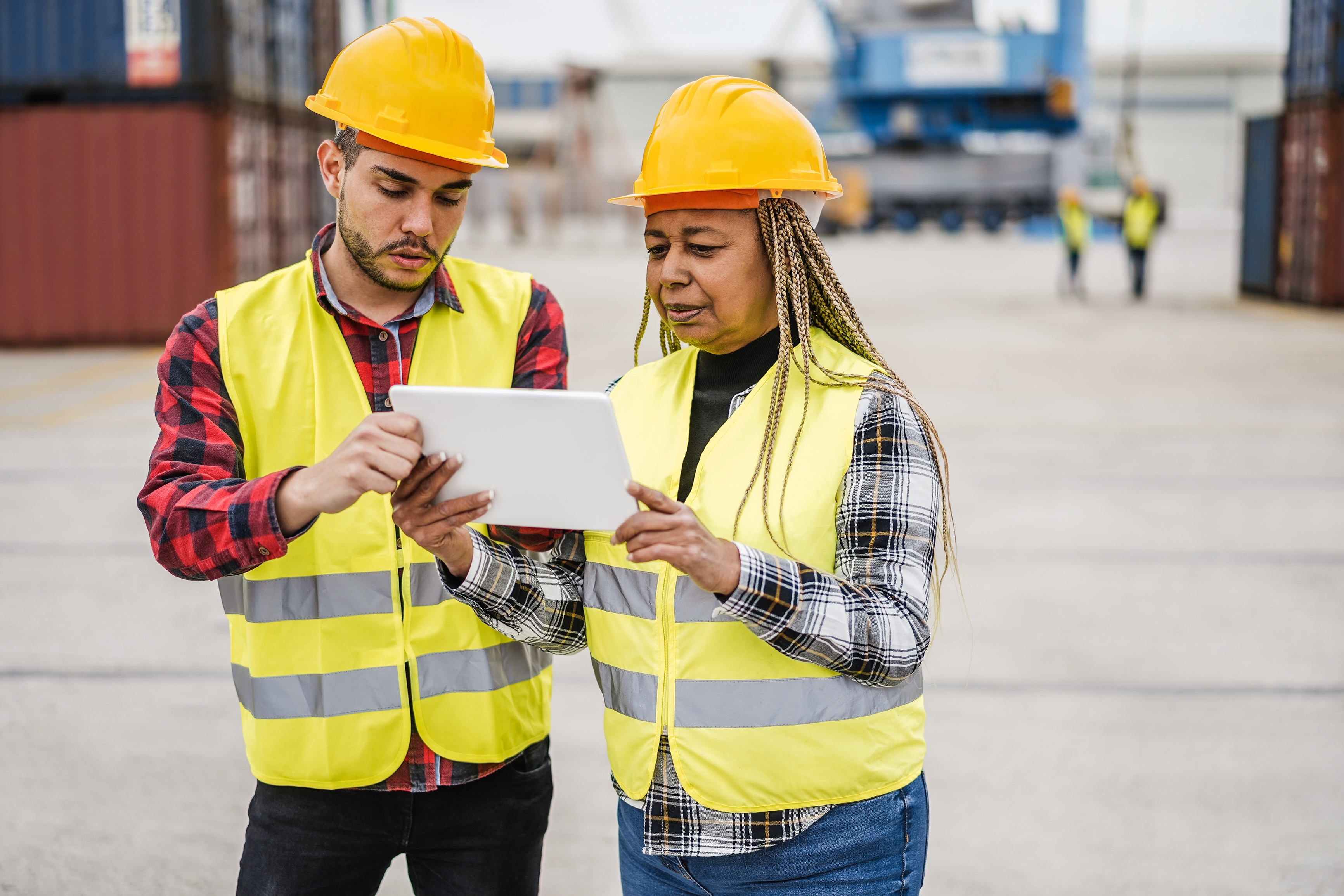 2025-05_multiracial-workers-controlling-shipping-containers-2250265971.jpg